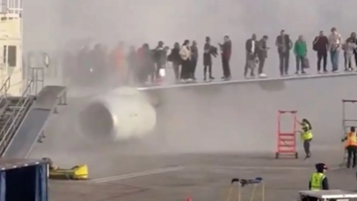 Passengers escape on to wing after plane catches fire